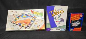 lot 240 image: Set of 3 Board Games and Card Holder Monopoly, Taboo, Dual Deck Revolving Card Holder