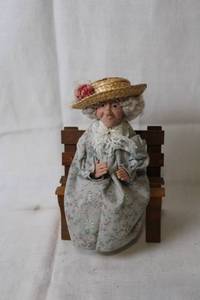 lot 193 image: Charming Porcelain Elderly Lady Doll with Handcrafted Bench