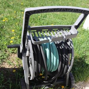 lot 102 image: Garden hose caddy with hoses