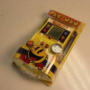 Handheld PAC MAN video game in original packaging