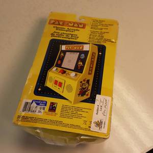 Handheld PAC MAN video game in original packaging