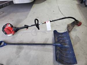 lot 222 image: Troy Built gas weed whip and a shovel