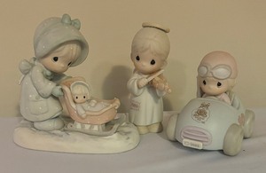 lot 109 image: Precious Moments Figurines including January, Oh Holy Night and Ten Years and Still Going Strong