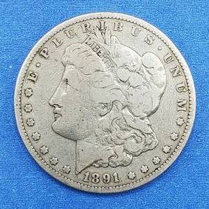 lot 99 image: 1891-CC Morgan Silver Dollar