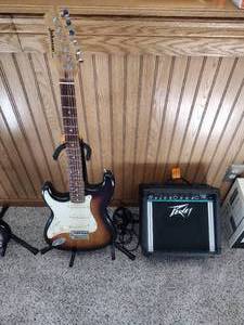 lot 13 image: Vintage Johnson by AXL electric guitar with Peavey Rage 108 Amplifier and guitar stand.