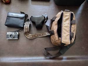 lot 92 image: Bushnell binoculars, Olympus 35 RC camera, minolta x-700 camera with bag