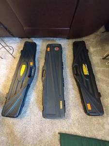 lot 102 image: Thompson hard case gun case, Plano hard case gun case, and Thompson Chicago typewriter hard case gun case
