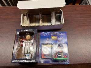lot 116 image: Small Box of Basketball and Football Trading Cards, Carlos Correa Puerto Rico Flag Bobblehead and 1998 Edition Mark McGwire Starting Lineup Collectible