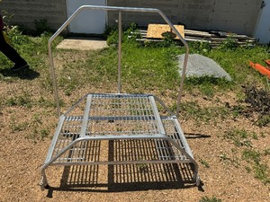 lot 136 image: Aluminum Staircase.  48 x 26.  Top platform is  24 x 24.  20 to top step. 50 To top rail.