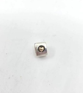 lot 146 image: Pandora Sterling Silver & 14K Gold Heart Two-Tone Charm
