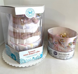 lot 17 image: Honest Co. Mini Diaper Cake with Baby Care Items and Wilton Favor Kit