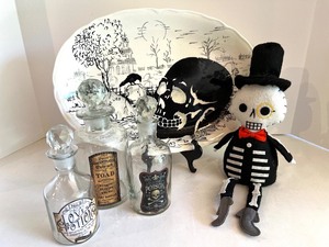 lot 29 image: Halloween Decor Set Maxcera Skull Plate, Apothecary Bottles, Plush Skeleton Doll
