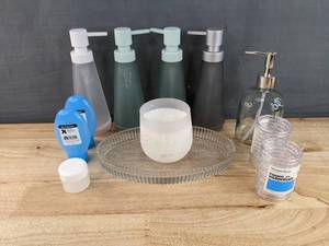 lot 105 image: Brand New Bathroom Accessories 5 Soap Pumps, 24 Clear Shower Rings, 2 Blue Gravity Feed Bottles, Candle, Glass Tray and More N