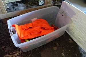 lot 239 image: Bin with Hunting Coveralls