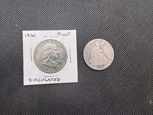 lot 23 image: 1853O & 1961 Proof Half Dollars. Details The 1853O is damaged in the areas where the arrow would be.