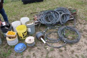 lot 21 image: Collection of Electric Fence Supplies Including Wire, Insulators, and Energizer