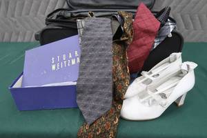 lot 145 image: CARRY ON LUGGAGE FULL OF DESIGNER TIES  BONUS SHOES