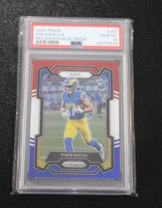 lot 157 image: 2023 Prizm Red White Blue Puka Nacua #357 Rookie Card PSA 10