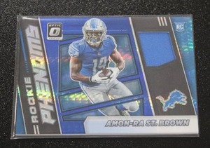 lot 110 image: 2021 Optic Rookie Phenoms Blue Amon-Ra St. Brown Jersey Rookie Card