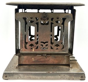 lot 31 image: Antique Metal Toaster with Intricate Design