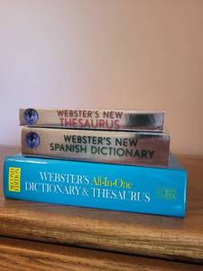 lot 734 image: Set of Websters Reference Books Including Dictionary, Thesaurus, and Spanish Dictionary