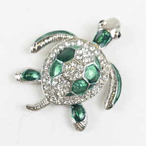 lot 19 image: Beautiful Silver Tone Base Metal Green Enameled Rhinestone Accented Turtle Magnet.