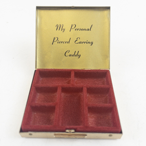 lot 59 image: My Personal Pierced Earring Caddy Gold Tone Base Metal Earring Caddy.