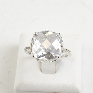 lot 73 image: Checkered Cushion Cut CZ Silver Tone Base Metal Engagement Style Ring. Size 7.75 - 8.