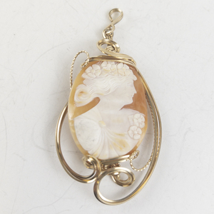 lot 233 image: Ornate Wire Wrapped Carved Shell Cameo gold tone Base Metal pendant (no chain). New Old StockEstimated Replacement value $250