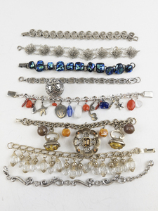 lot 267 image: Group of 7 Chunky, Charm Base Metal Bracelets .