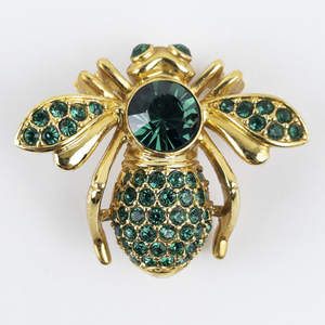 lot 215 image: Nolan Miller Green Rhinestone Bug Gold Tone Base Metal Brooch .
