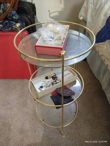 lot 359 image: Brass & Glass Table With Contents - Vintage Wallets & Religious Jewelry