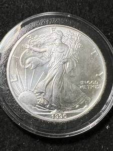lot 101 image: 1990 AMERICAN SILVER EAGLE 1 TROY OZ .999 FINE SILVER IN AIRTITE
