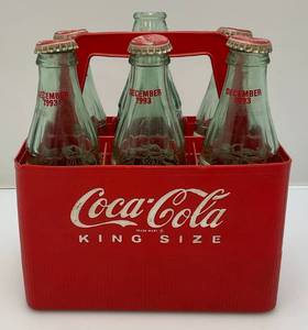 lot 130 image: 1923 Coca-Cola Plastic Carrier With 1993 Season Greetings Bottles