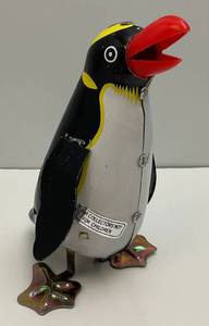 lot 232 image: 1980s  5.75 Tin Litho Rock And Roll Wind Up Penguin (Works) No Key