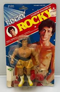 lot 250 image: Est. $200.00 - $300.00 1983 PAC Phoenix Toys ROCKY Sylvester Stalllone As Rocky Fully poseable Doll On Original Card (New Old Stock) Missing Belt  Packaging Shows Wear