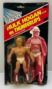 lot 252 image: Est. $200.00 - $300.00 1983 PAC Phoenix Toys ROCKY Hulk Hogan As Thunderlips Fully poseable Doll On Original Card (New Old Stock)  Packaging Shows Wear