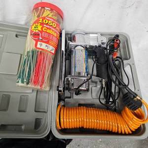 lot 91 image: 12 Volt Portable Air Compressor and 1050 Pack of Zip Ties