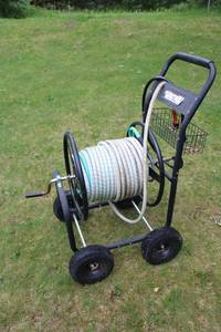 lot 84 image: Garden Hose Reel Cart with Adjustable Hose Nozzle
