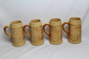 lot 40 image: Set of 4 Vintage Hull Yellow Ware Alpine Steins