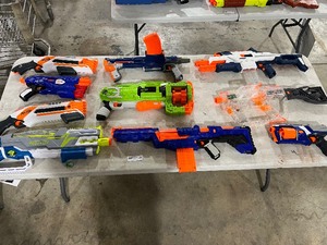 lot 56 image: TABLE FULL OF NERF GUNS