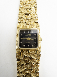 lot 126 image: Ladys Geneva  Black Dial Nugget Style Gold Tone Base Metal Quartz Analog watch. Does not run