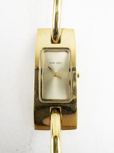 lot 127 image: Ladys Nine West Curved Tank Style Gold Tone Base Metal Quartz Analog watch. New battery
