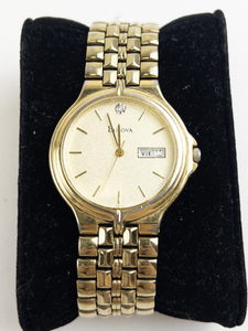 lot 154 image: Mens Bulova Sandblasted dial with stone at 12 o clock with daydate gold tone base metal Quartz Analog watch. New battery