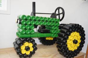 lot 28 image: John Deere Farm Tractor Made Out of Cans