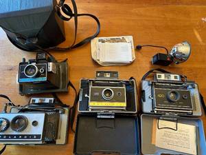 lot 47S image: Collection of 4 Vintage Polaroid Cameras with Accessories