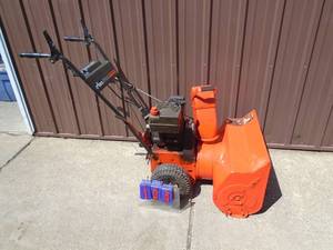 lot 104 image: Ariens ST504 snow blower. Used condition. Tested & works. As shown.
