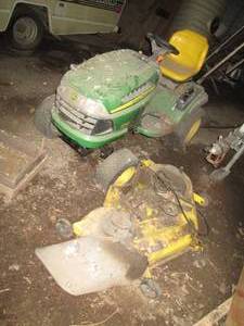 lot 707 image: John Deere riding mower with deck, missing one rear wheel, ran when last used but has been stored for a few years