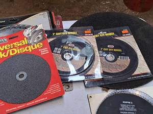 lot 818 image: (2) 14 Steel Cut-off Blades (one new, one used), (2) 7 Cut-Off Wheel (new) and (1) 7 Universal (new)