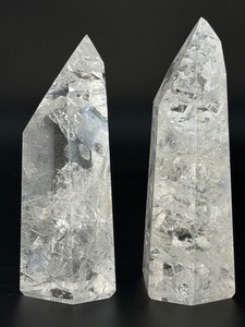 lot 9 image: Two mesmerizing Crackle Quartz tower, its interior fractured patterns catching the light likefrozen lightning. 2 lbs 6.4 oz.  1.090 kg.